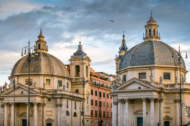 The beautiful domes of the twin Baroque churches of Piazza del Popolo in the district of Piazza di Spagna, in the historic heart of Rome. On the left, the church of Santa Maria in Montesanto, built in 1662 based on a project by Gian Lorenzo Bernini (1598-1680). On the right, the Church of Santa Maria dei Miracoli, built in 1681 by the architect Carlo Rainaldi (1611-1691). In 1980 the historic center of Rome was declared a World Heritage Site by Unesco. Image in high definition format.